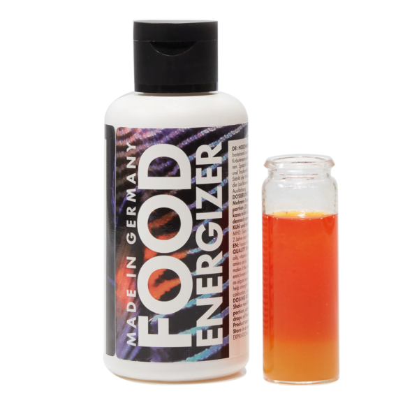 Bottle of Food Energizer supplement with a small glass vial containing orange liquid beside it.